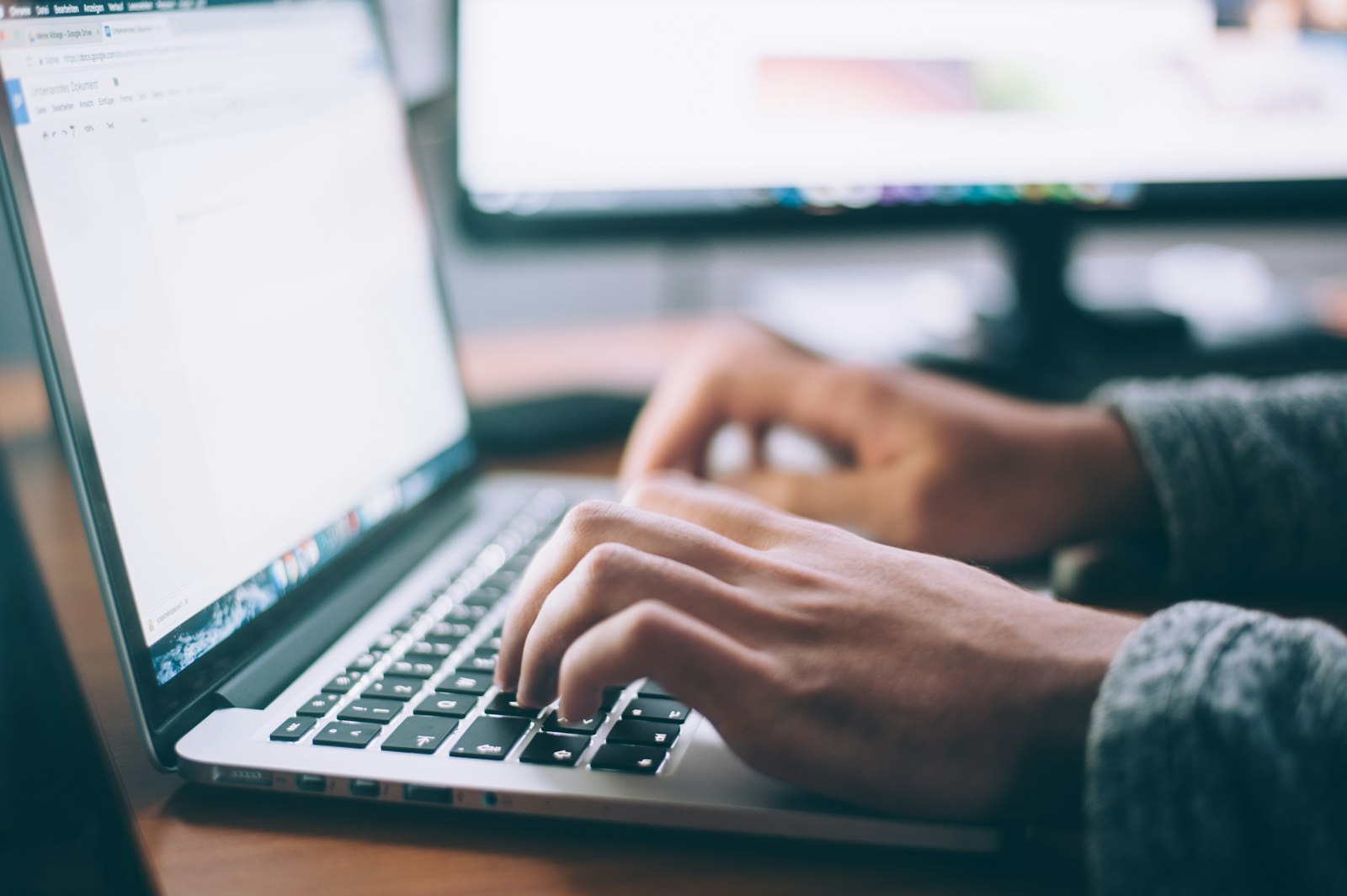 Hands on a laptop keyboard, building a website