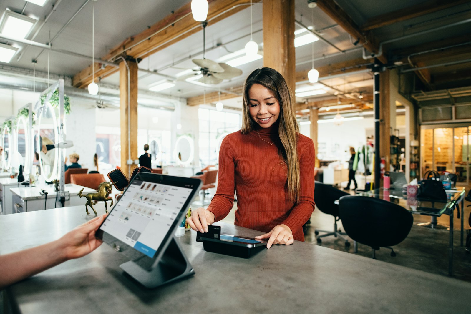 A modern front desk serving a customer