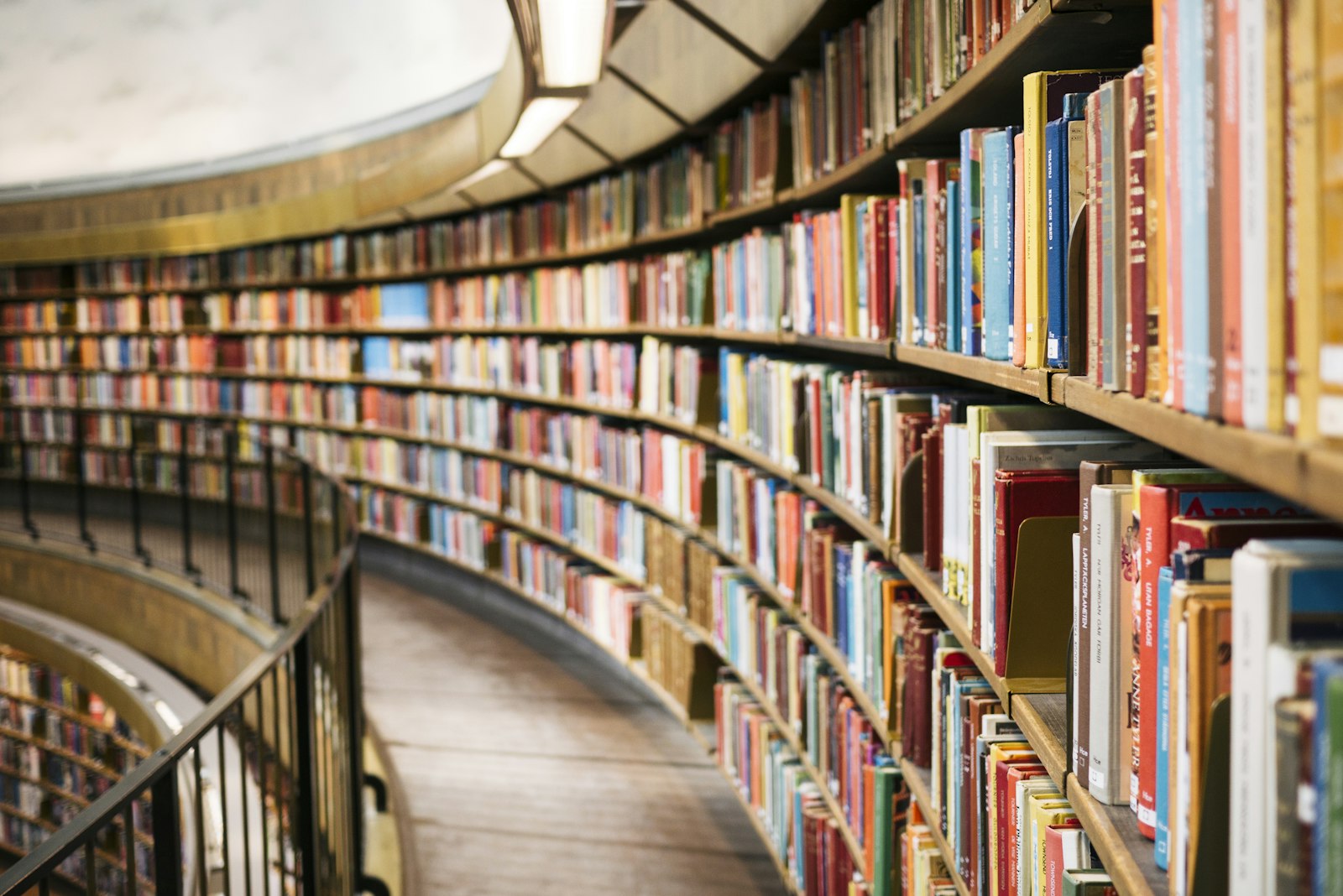 Curved library shelves full of books — Claremont, the city of trees and PhDs